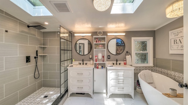 38 Kings Ln, Cape May Court House, NJ 08210 - bathroom featuring a skylight, a tile shower, two vanities, a freestanding bath, and ornamental molding