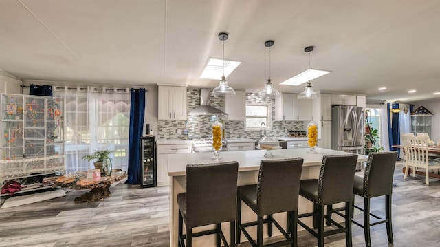 38 Kings Ln, Cape May Court House, NJ 08210 - kitchen with wall chimney range hood, stainless steel appliances, light countertops, decorative backsplash, and recessed lighting