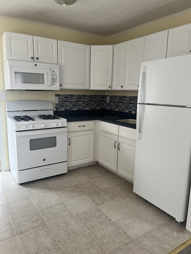 kitchen featuring backsplash, crown molding, white cabinets, and white appliances