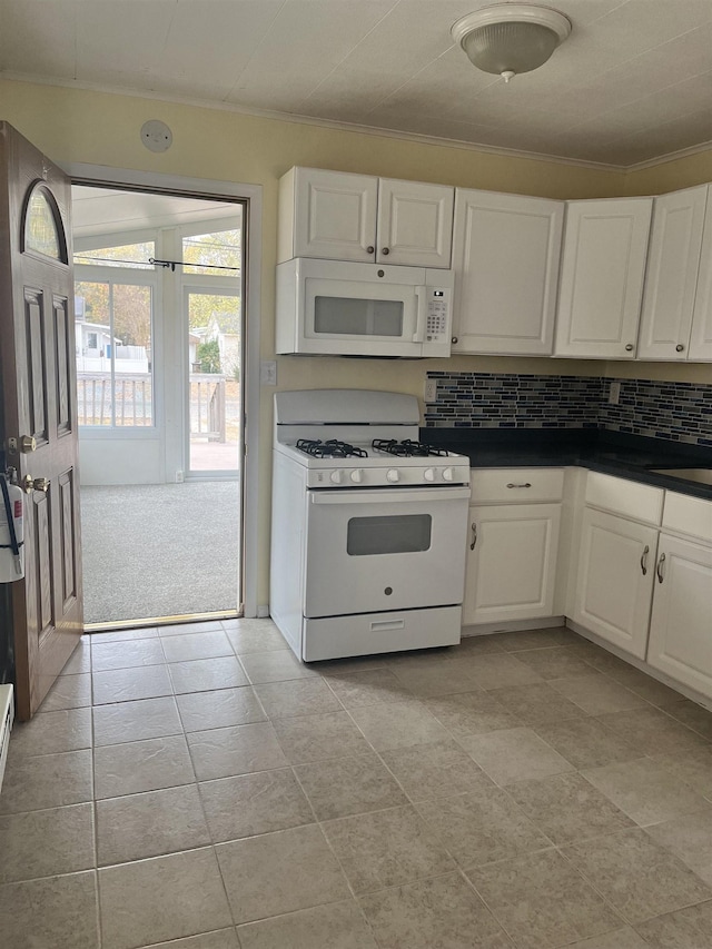 kitchen with white cabinets, white appliances, light carpet, and tasteful backsplash