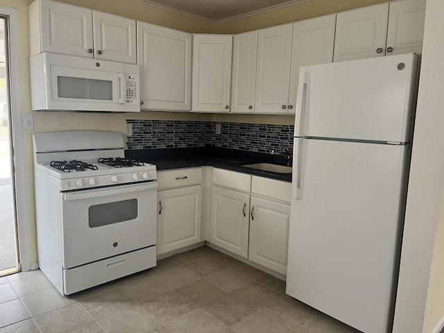 kitchen with white appliances, white cabinets, crown molding, sink, and tasteful backsplash