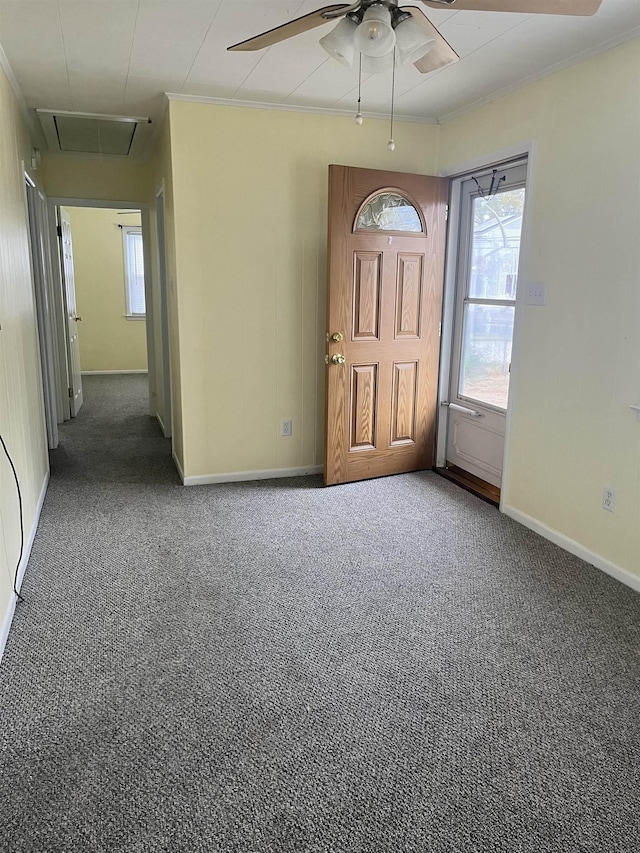 carpeted entrance foyer featuring ceiling fan and ornamental molding