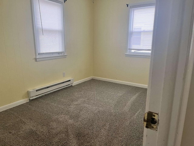 carpeted empty room featuring a baseboard radiator