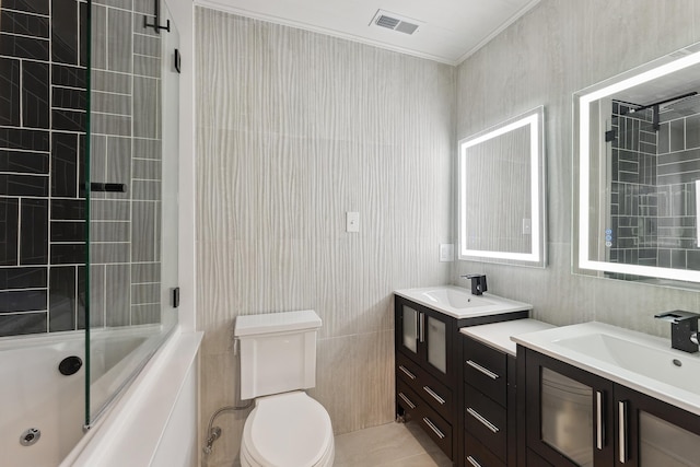 full bathroom featuring combined bath / shower with glass door, vanity, tile patterned floors, and tile walls