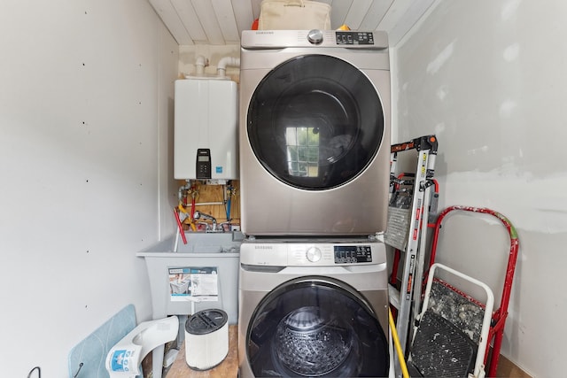 laundry area with tankless water heater, sink, and stacked washer / dryer