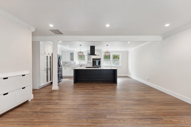 kitchen featuring ventilation hood, stainless steel appliances, a kitchen island, pendant lighting, and white cabinetry