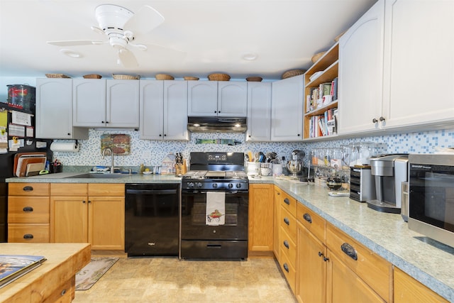 kitchen with black appliances, under cabinet range hood, backsplash, and a sink