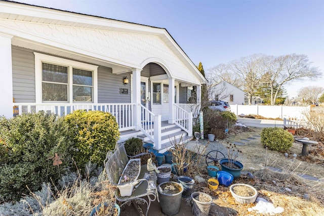 exterior space with fence and a porch