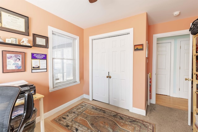 carpeted home office with baseboards