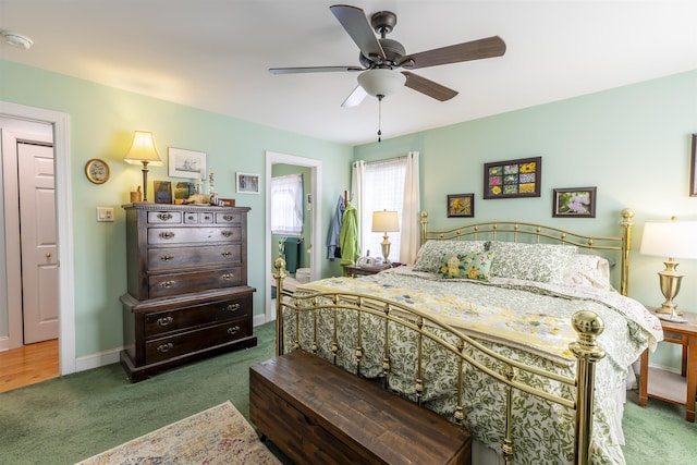 carpeted bedroom featuring ceiling fan, baseboards, and ensuite bathroom