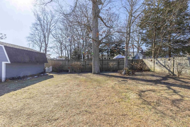 view of yard with cooling unit and a fenced backyard