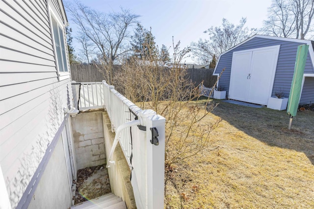 exterior space featuring an outdoor structure, a storage unit, and fence