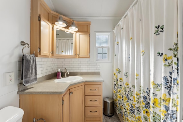 full bathroom featuring toilet, backsplash, and vanity