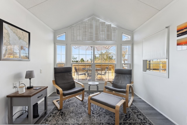 living area with lofted ceiling, ornamental molding, dark wood-style flooring, and baseboards