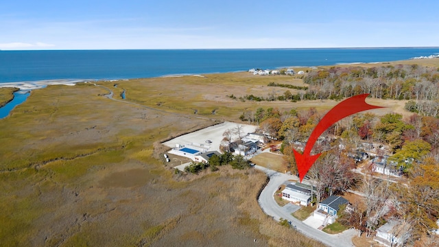 birds eye view of property featuring a water view and a view of the beach