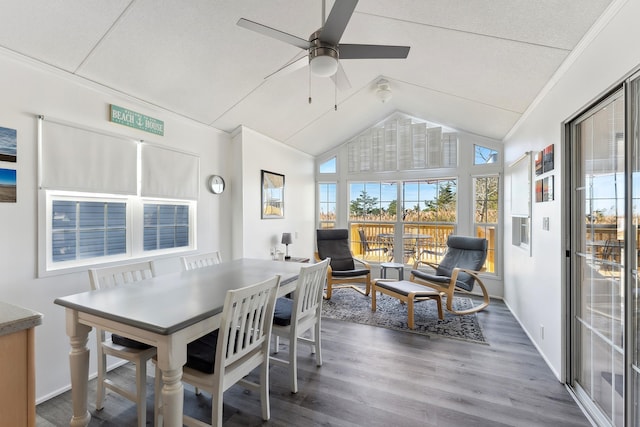 dining space with ornamental molding, ceiling fan, vaulted ceiling, wood finished floors, and baseboards