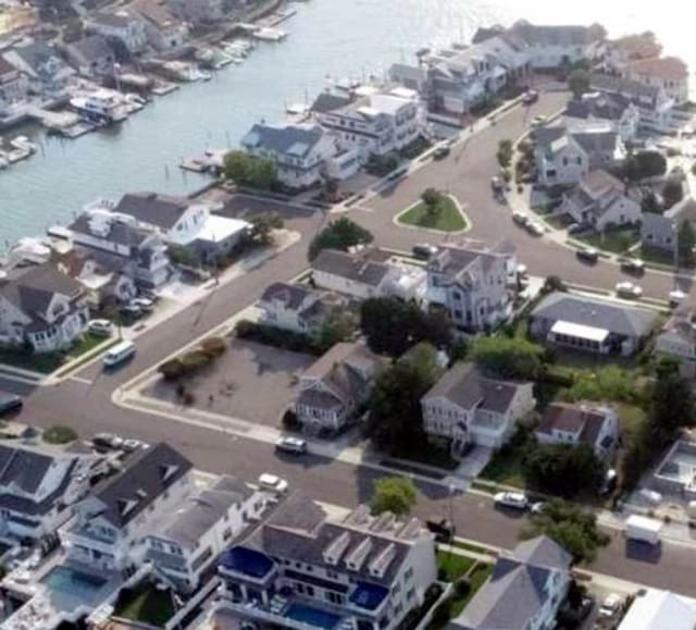 birds eye view of property with a water view and a residential view