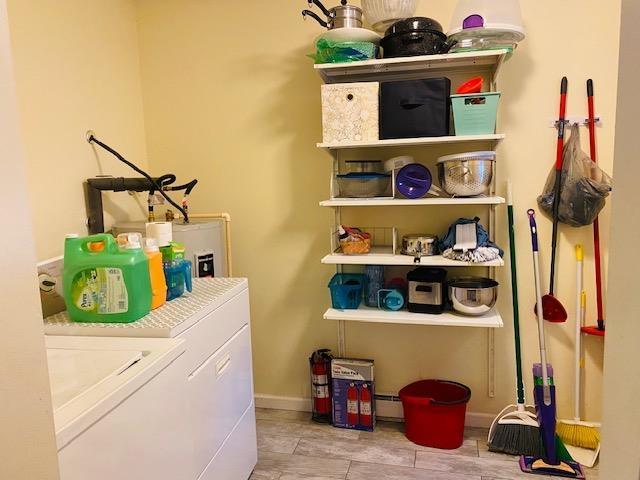 washroom with washing machine and clothes dryer and a baseboard radiator