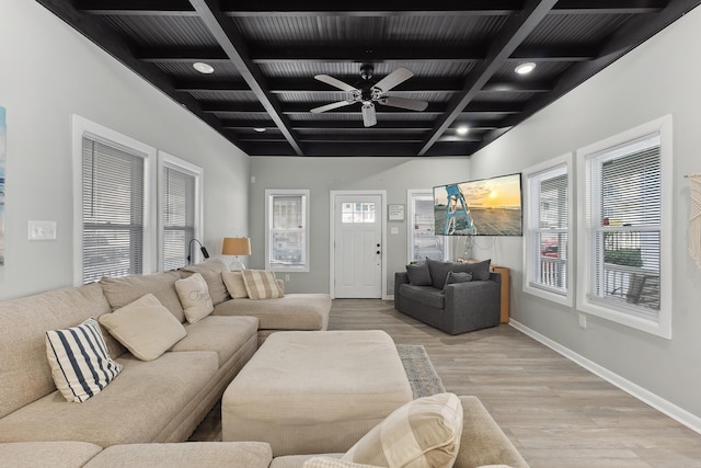 living room with coffered ceiling, ceiling fan, beamed ceiling, and light hardwood / wood-style flooring