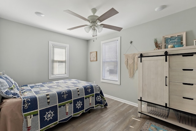 224 E Leaming Ave, Wildwood, NJ 08260 - bedroom with hardwood / wood-style floors, ceiling fan, and a barn door