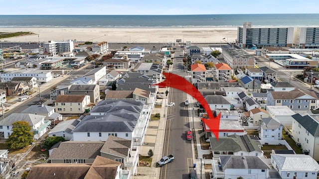 drone / aerial view featuring a water view and a beach view