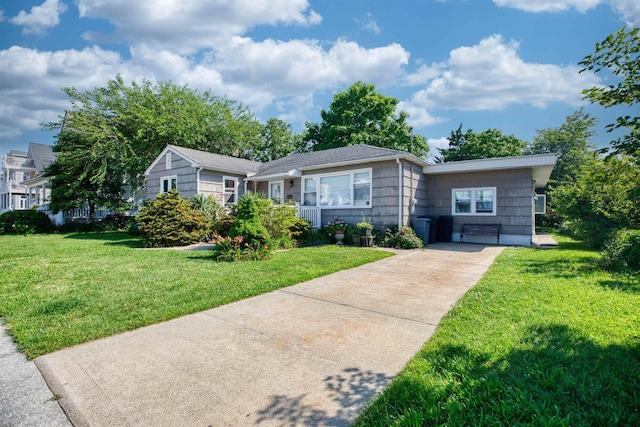 222 E 2nd Ave, North Wildwood, NJ 08260 - view of front facade with concrete driveway and a front yard