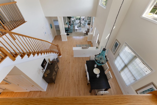 living room with hardwood / wood-style flooring and a towering ceiling