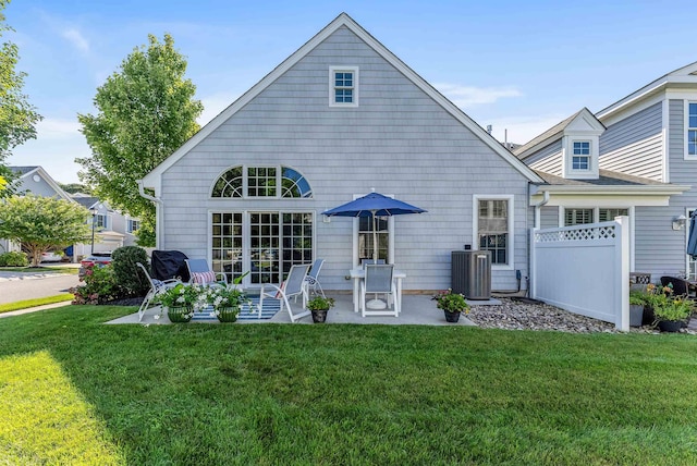 back of property featuring a yard, a patio, and central AC