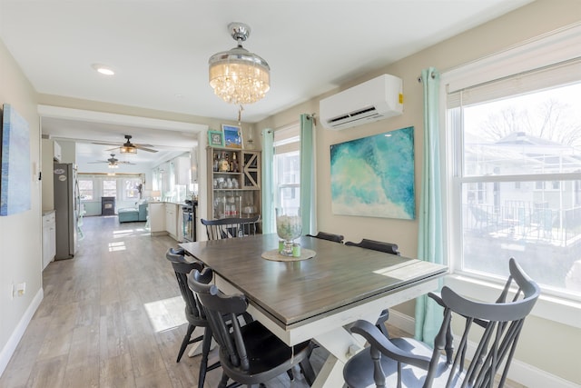 151 Stimpson Ln, West Cape May, NJ 08204 - dining room featuring a wall mounted air conditioner, baseboards, healthy amount of natural light, and light wood finished floors