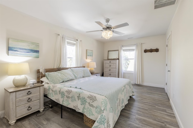 151 Stimpson Ln, West Cape May, NJ 08204 - bedroom with multiple windows, baseboards, wood finished floors, and a ceiling fan
