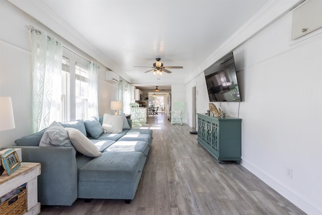 151 Stimpson Ln, West Cape May, NJ 08204 - living area featuring a wall mounted AC, ceiling fan, wood finished floors, crown molding, and baseboards