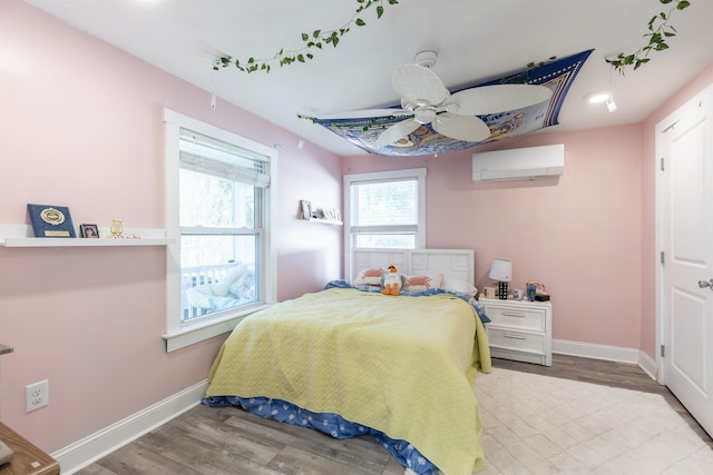 151 Stimpson Ln, West Cape May, NJ 08204 - bedroom featuring a wall unit AC, baseboards, and wood finished floors