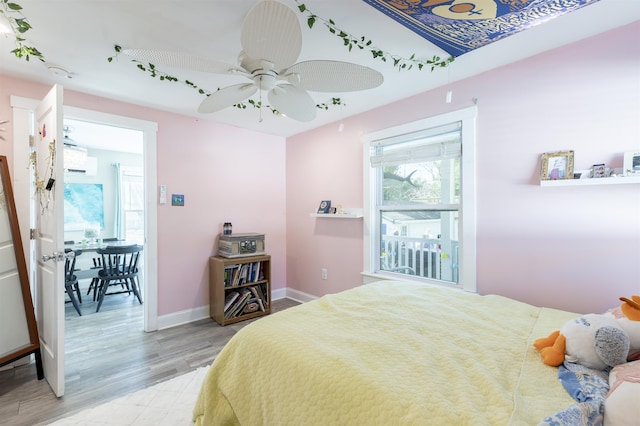 151 Stimpson Ln, West Cape May, NJ 08204 - bedroom with multiple windows, light wood-style floors, baseboards, and a ceiling fan