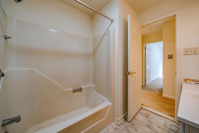 bathroom with a tub to relax in, baseboards, a shower, tile patterned floors, and vanity