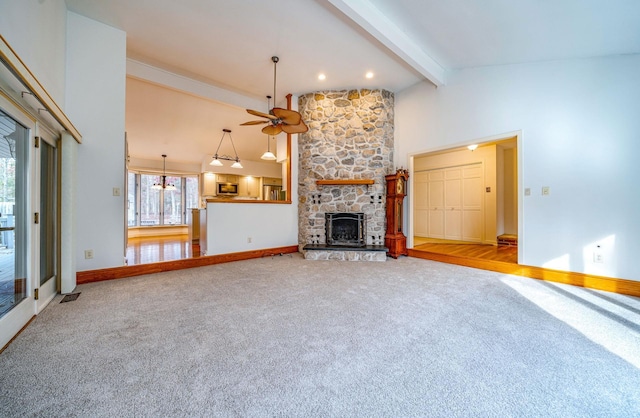 unfurnished living room with baseboards, beamed ceiling, carpet, a fireplace, and high vaulted ceiling