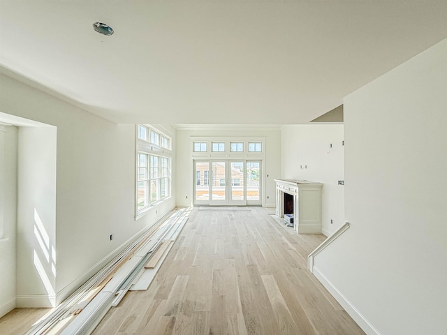 268 32nd St W, Unit West, Avalon, NJ 08202 - unfurnished living room featuring light wood finished floors and a fireplace