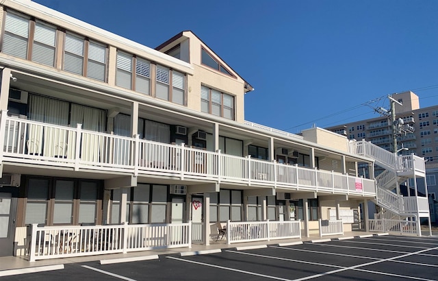 view of building exterior featuring uncovered parking