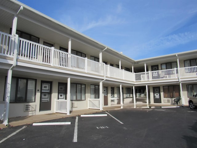 view of property featuring uncovered parking