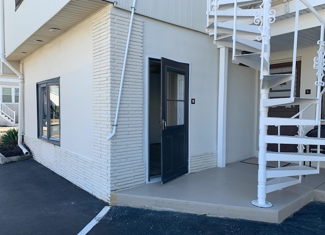 property entrance with brick siding