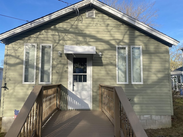 back of house with a deck