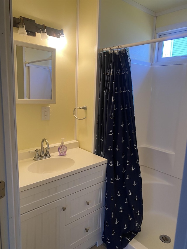 bathroom featuring curtained shower and vanity