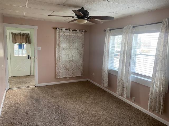 carpeted empty room featuring ceiling fan