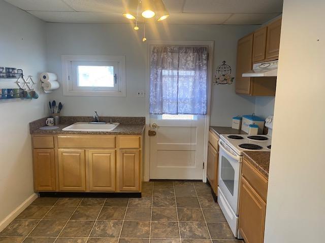 kitchen featuring plenty of natural light, white electric range, and sink