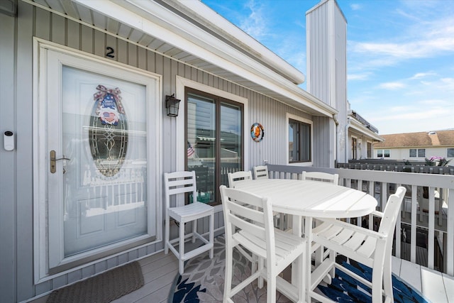 280 79th St Unit 2, Avalon, NJ 08202 - entrance to property featuring outdoor dining area, a chimney, and board and batten siding