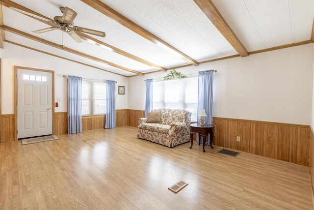 living area with wainscoting and visible vents