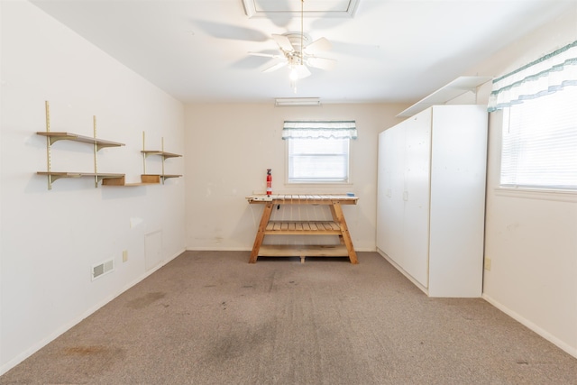 empty room with baseboards, ceiling fan, light colored carpet, and visible vents