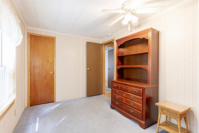 bedroom with crown molding, ceiling fan, and light carpet