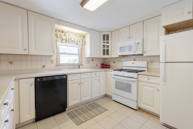 kitchen featuring decorative backsplash, white appliances, white cabinetry, a sink, and light tile patterned floors