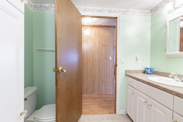 bathroom featuring vanity and toilet