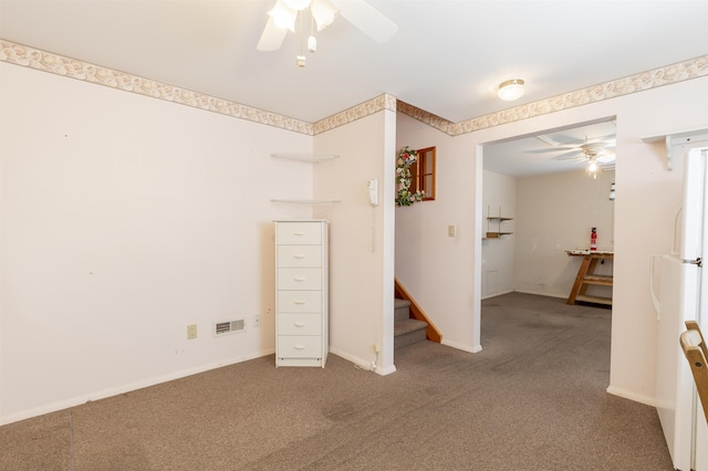 interior space with visible vents, carpet flooring, baseboards, and a ceiling fan